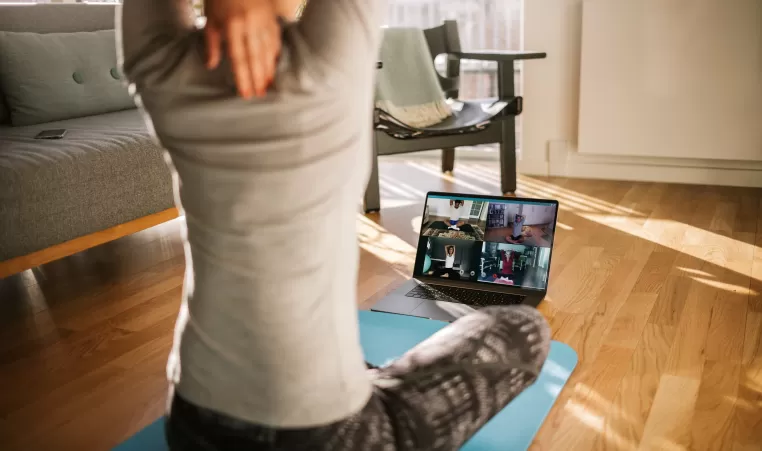 Adult stretching in front of computer