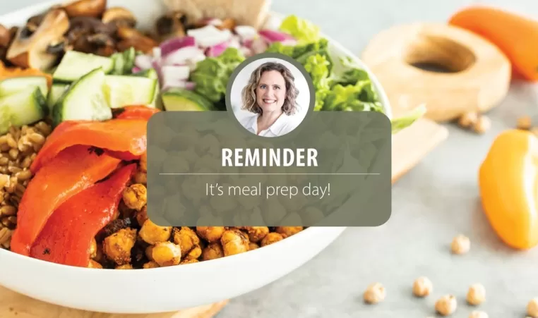 The background contains an image of a healthy prepared meal. There is text overlapped that reads "REMINDER: It's meal prep day!". The text at the bottom of the screen reads "Download your Healthy Eating Meal Plan today! FREE with a Y@Home+ Membership".